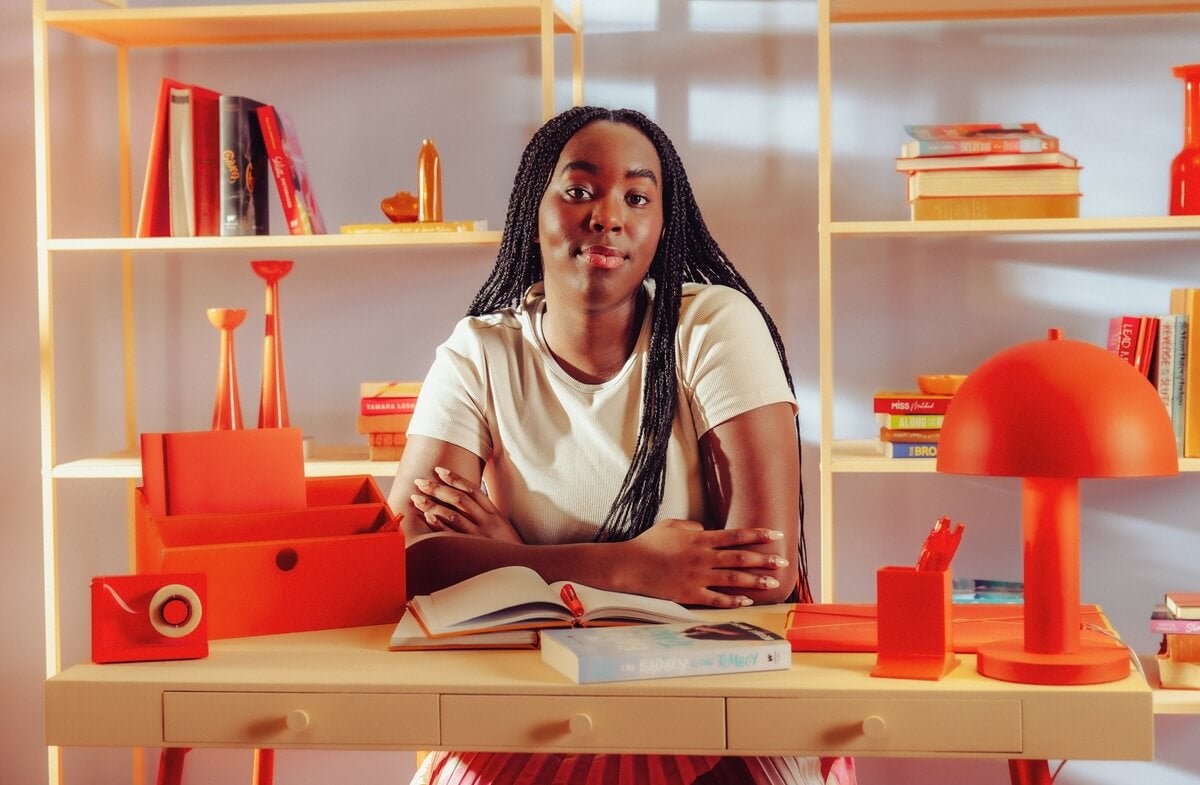 Image of writer writing in a book