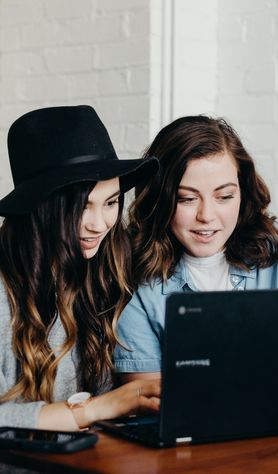 Two friends looking at laptop